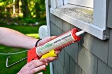 Technician applying insulation around window