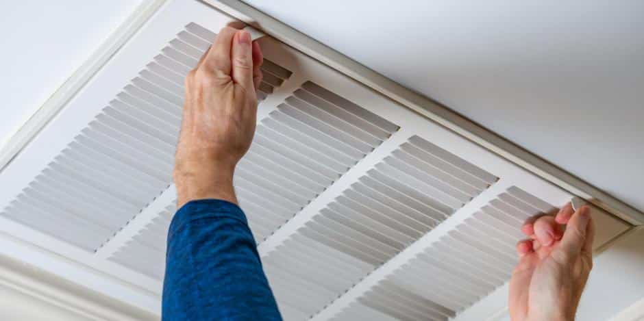 Technician opening ceiling vent